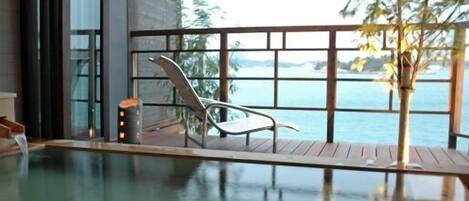 A modern indoor pool with a clear view of the ocean.