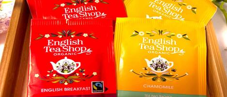 Four tea bags from English Tea Shop, two red and two yellow, with labels indicating 'English Breakfast' and 'Chamomile'.