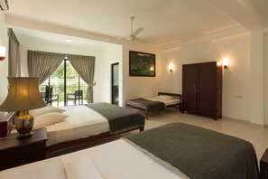 A hotel room with two beds, a ceiling fan, a painting, and a wardrobe. - Oruthota Chalets (Maberiyatenna)