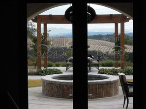 A gazebo with a circular fountain, outdoor seating, and a view of a vineyard. - The Inn at Croad Vineyards (Paso Robles)
