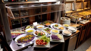 A buffet with various dishes including salads, vegetables, and a variety of other food options. - Kithala Resort (Thissamaharama)