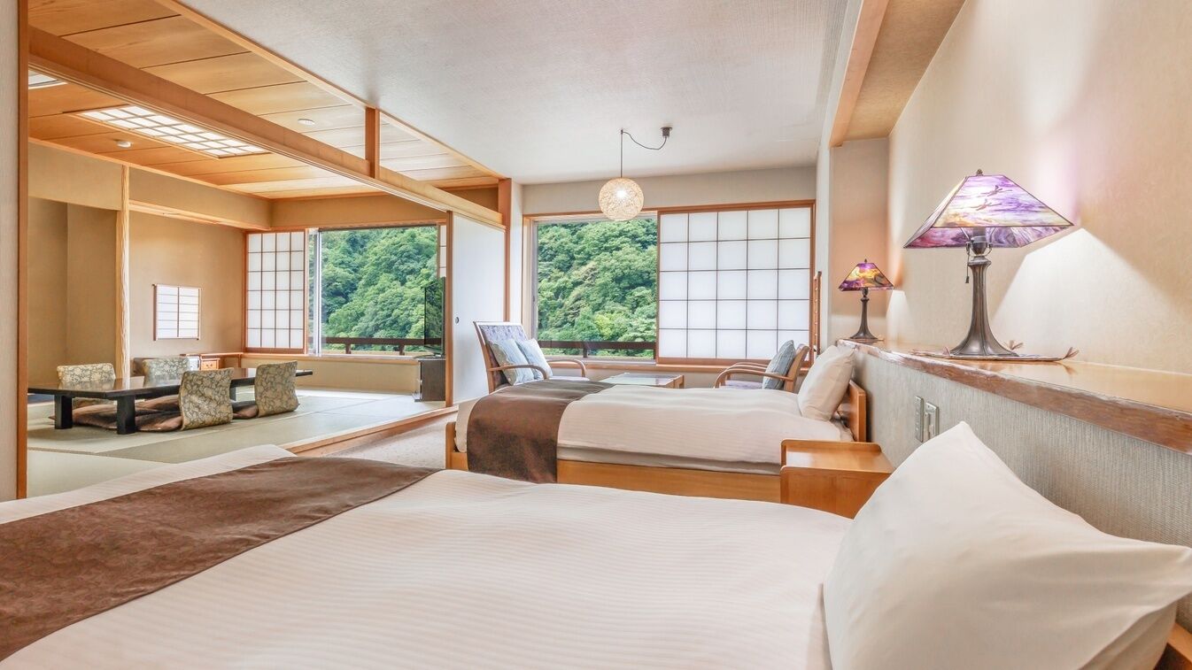 A traditional Japanese-style room with tatami flooring, a low wooden ceiling, and a view of lush greenery outside.