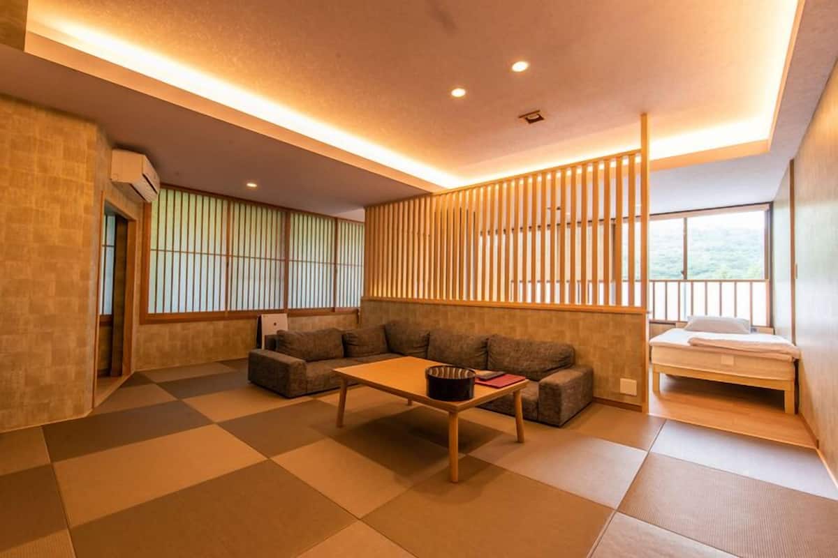 A modern interior with a sofa, a small table, and a bed.