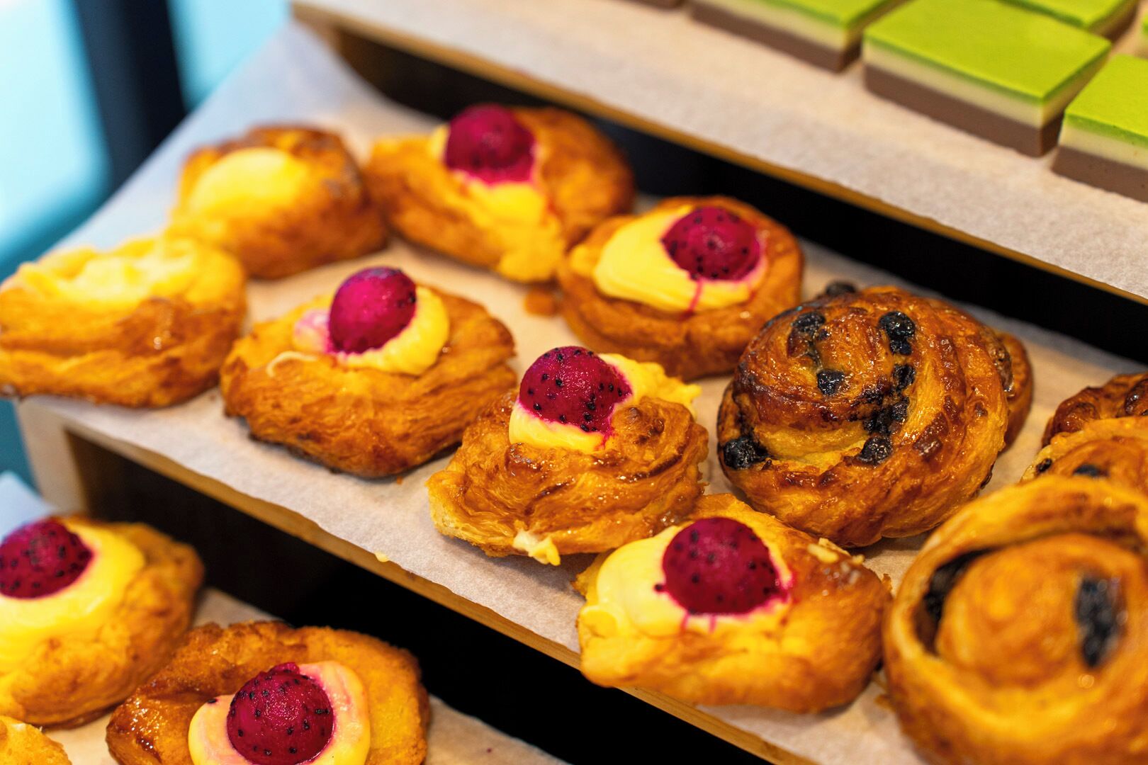 A tray of pastries with fruit toppings.