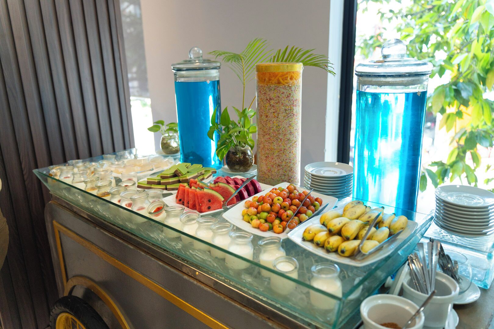 A buffet setup with various food items and beverages.