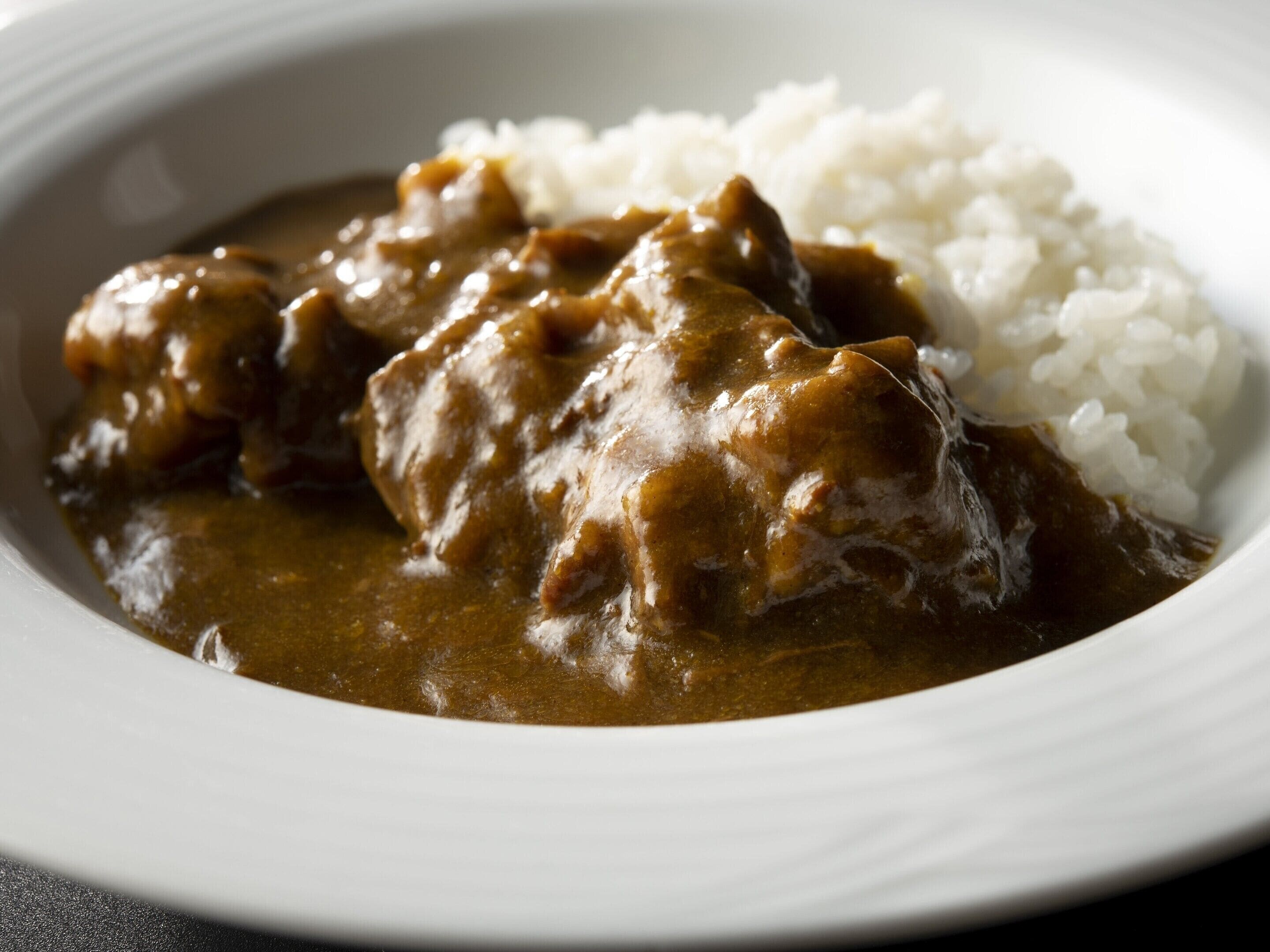 A plate of curry with rice.