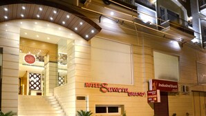 A hotel entrance with a staircase, a sign for 'Hotel Sawera Grand', and an 'IndusInd Bank' ATM. - Sawera Grand (Amritsar)