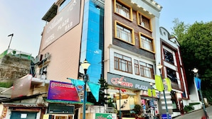 A multi-story building with a sign for 'QZone Plaza Hotel' on the upper left.