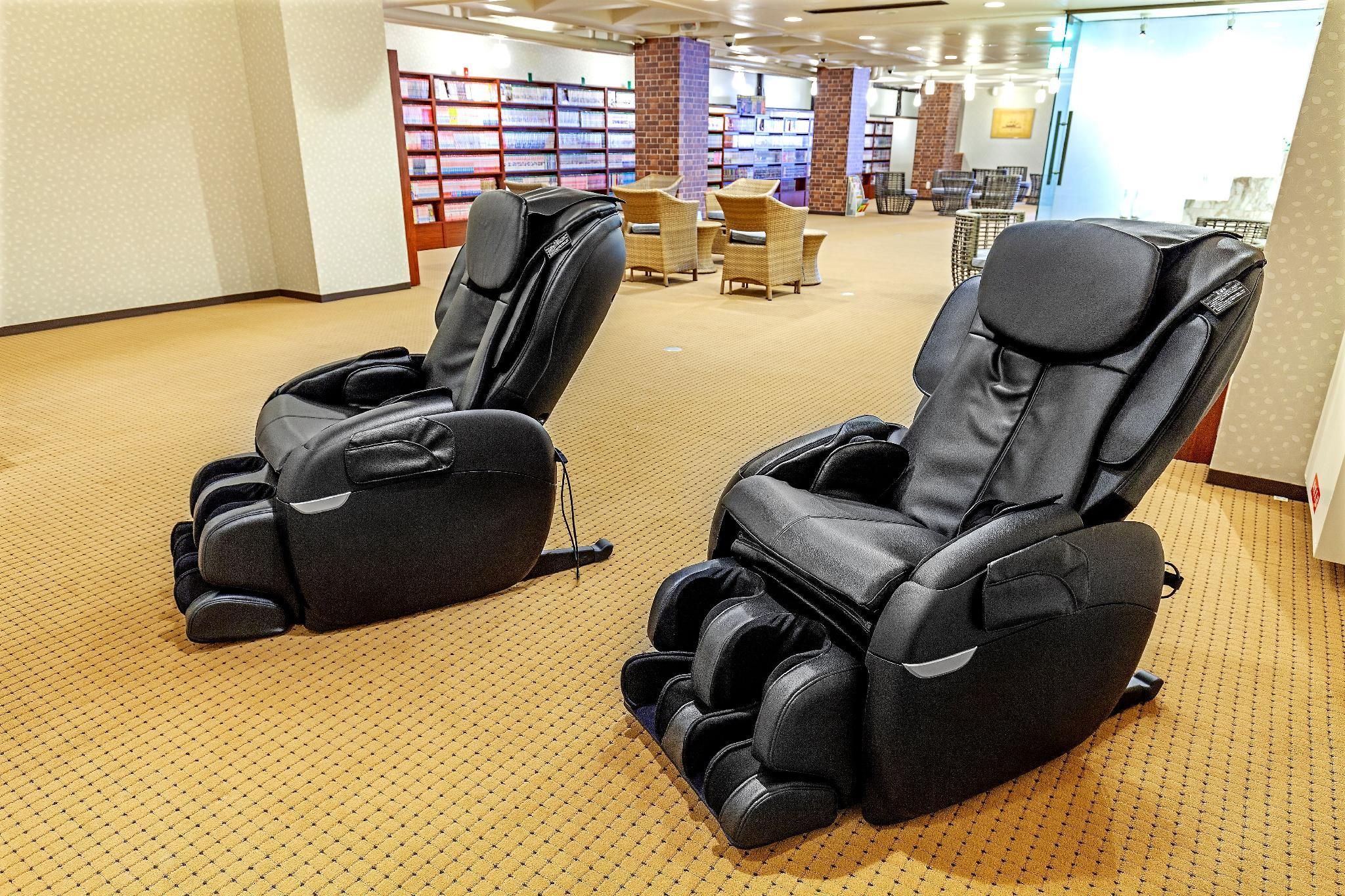 A room with massage chairs and a carpeted floor.