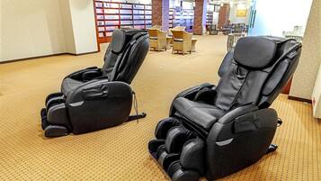 A room with massage chairs and a carpeted floor.
