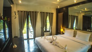 A hotel room with a large bed, a mirror, and a view of the outdoors. - Bura Lumpai (Pai)