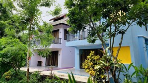 A two-story house with a balcony, surrounded by lush greenery. - Bura Lumpai (Pai)