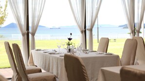 A table set for dining with a view of the sea and mountains. - Kurashiki Seaside Hotel (Kurashiki)