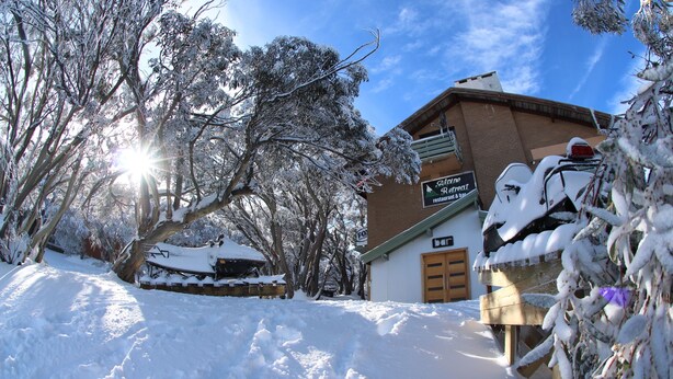 A snow-covered outdoor area with a building that has a sign reading "The Retreat restaurant & bar." - Alpine Retreat Mt Buller (Mount Buller)