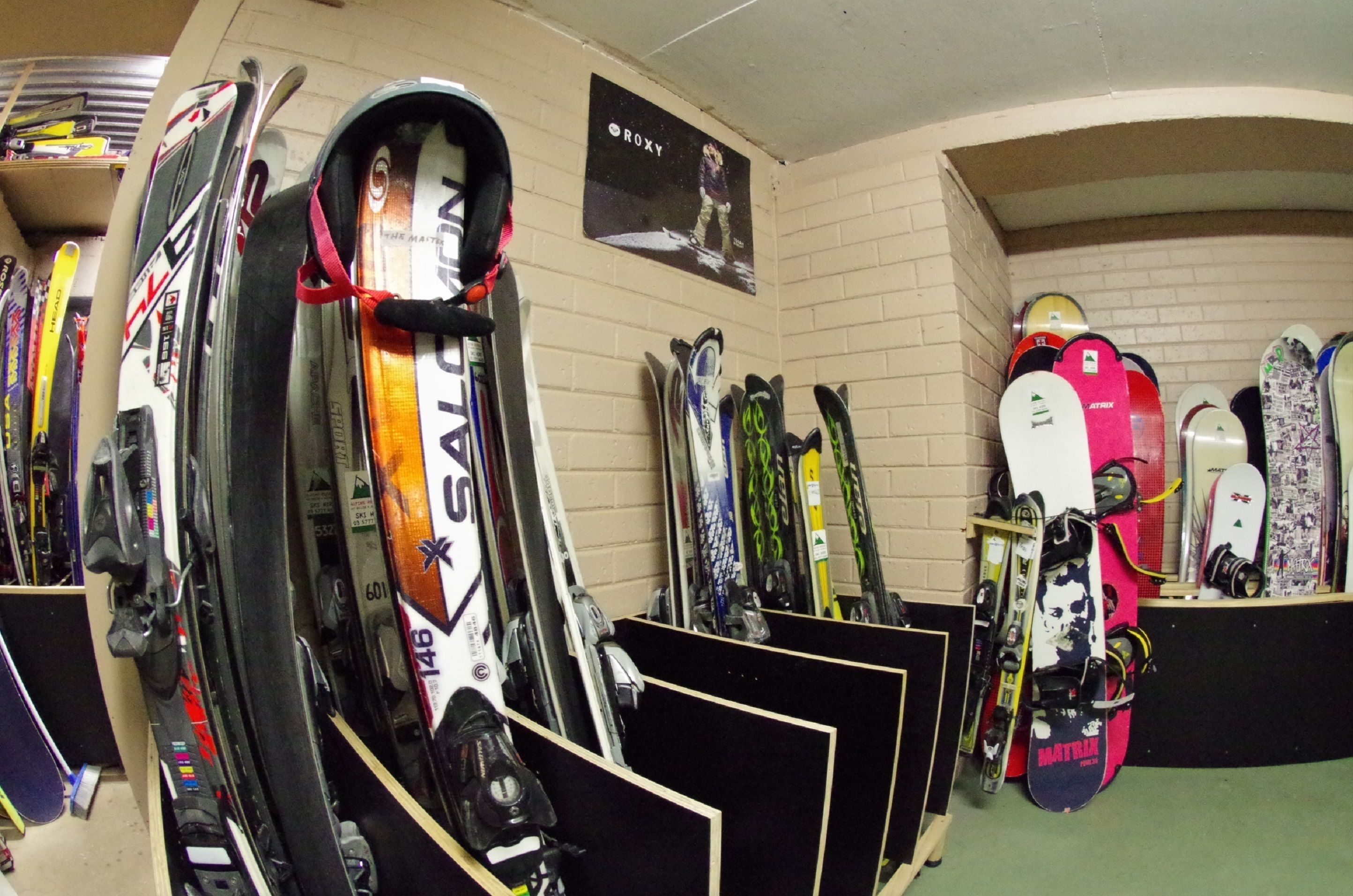 A ski shop with various skis and snowboards on display.
