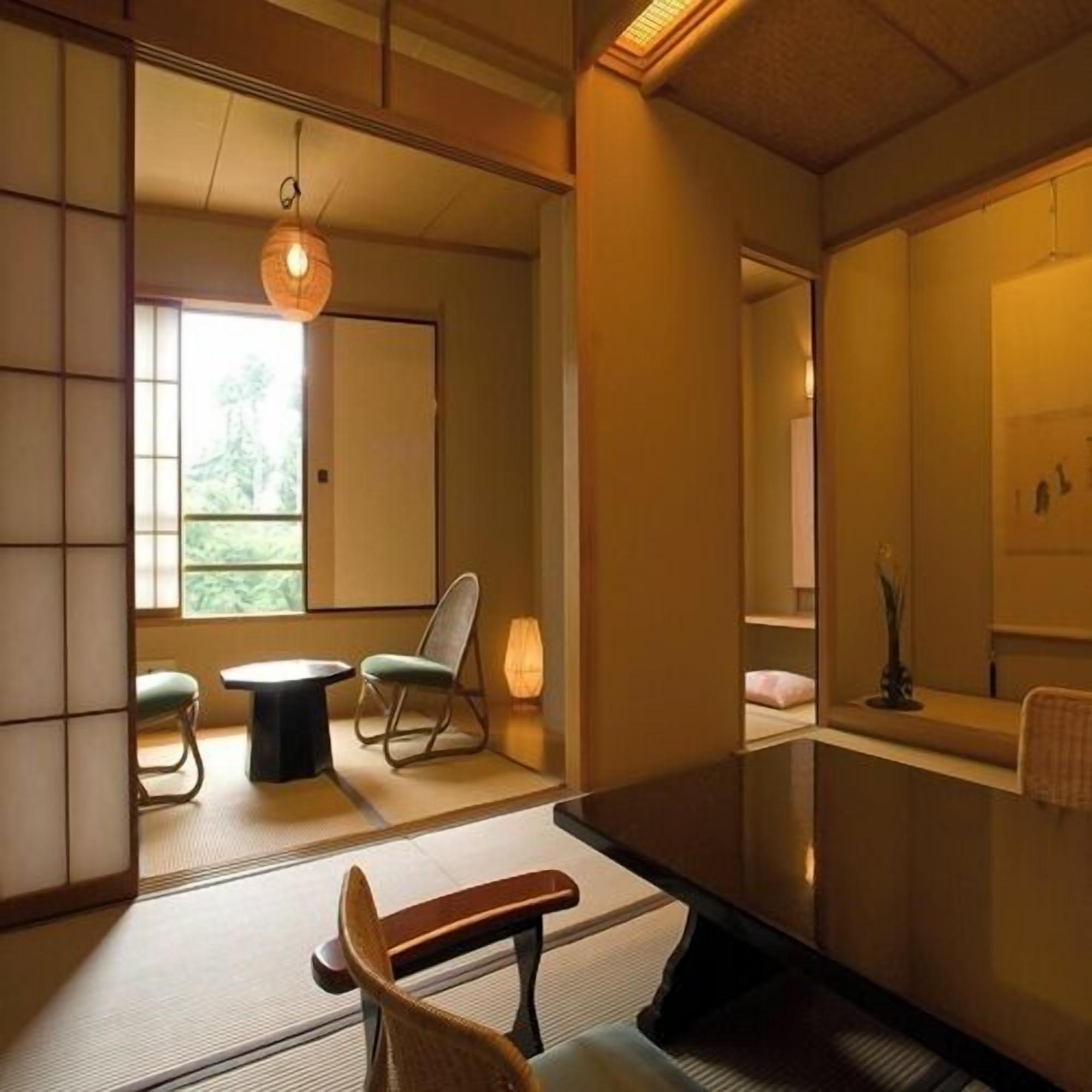 A traditional Japanese-style room with tatami flooring, a low table, a chair, and a hanging light fixture.