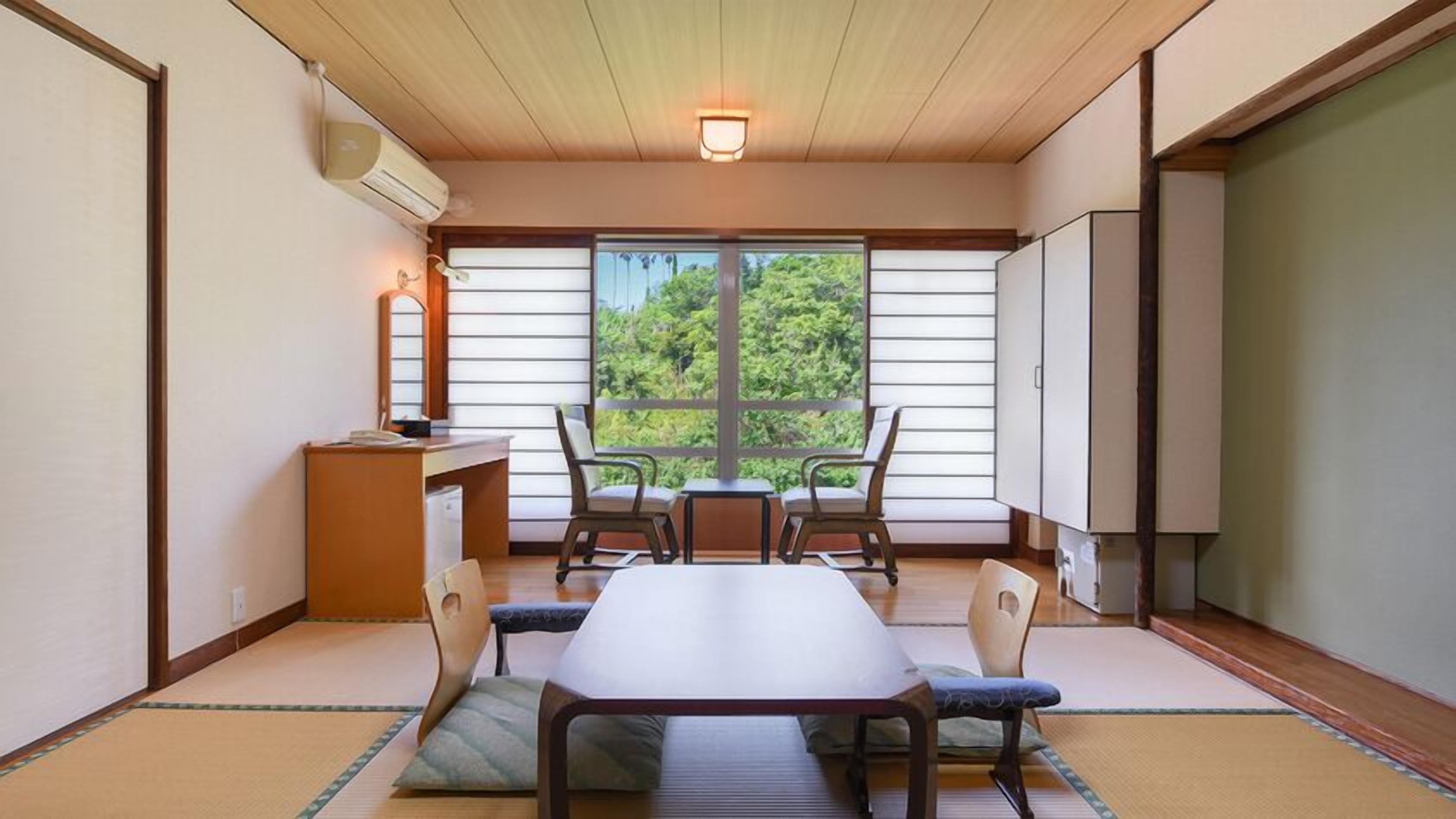 A traditional Japanese room with tatami flooring, a low table, and shoji screens.