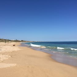 On the beach, white sand, beach umbrellas, beach towels