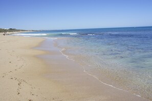 A beach with clear water, sandy shore, and footprints. - Beach Front The Wedge - Adults Only (Halls Head)