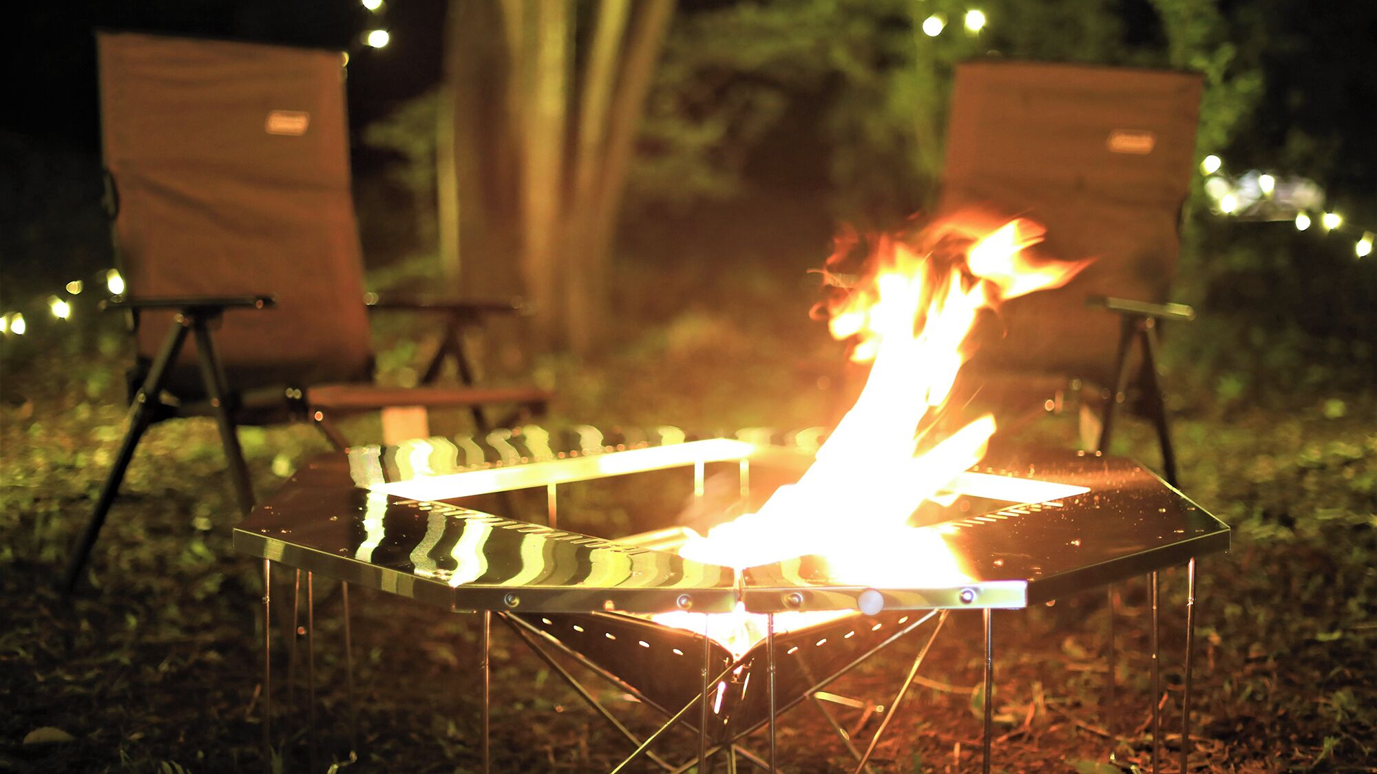 A campfire with chairs around it.