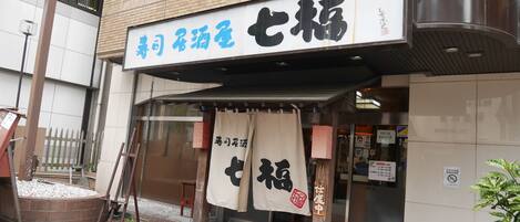 A building with a sign that reads "Special Room for the Elderly" and a red carpet leading to the entrance.