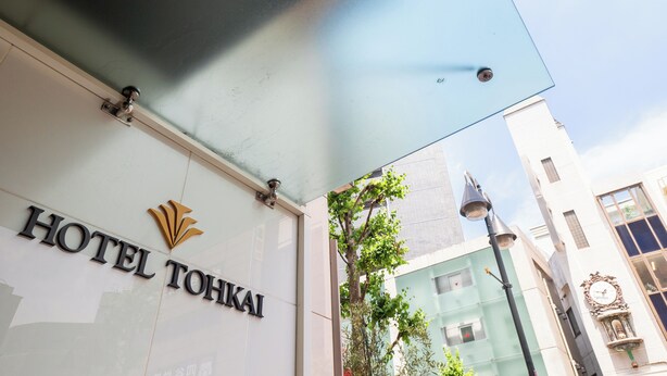 The exterior of Hotel Tohkai with a clear sign, a modern building facade, and a street lamp. - Hotel Tohkai (Atsugi)