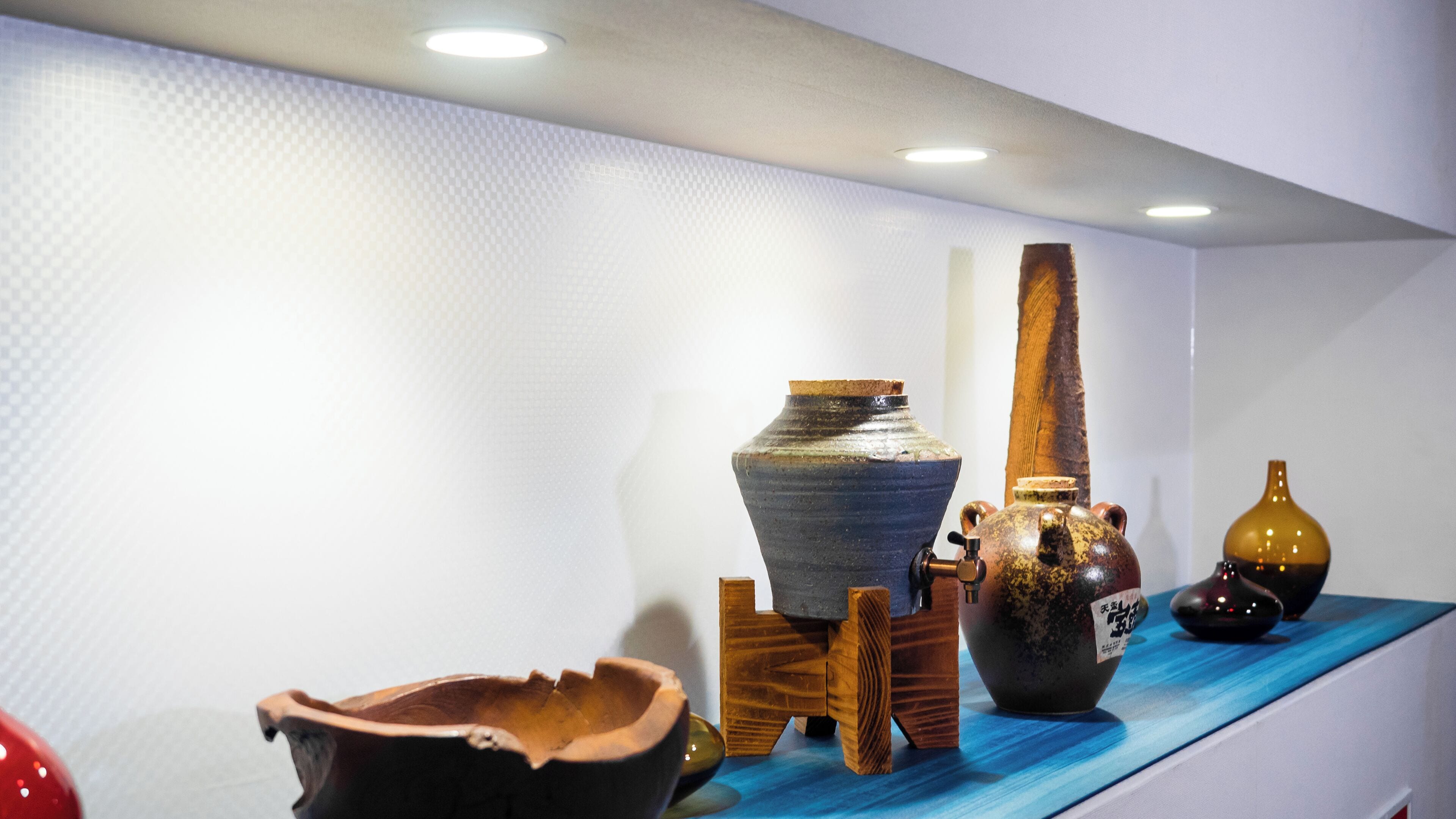 A display of various pottery items on a shelf.