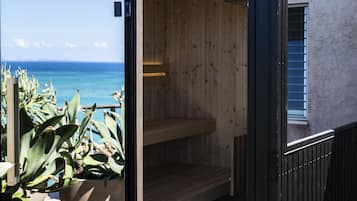 Relax in a serene sauna with a bench and potted plants nearby.
