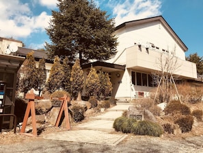A building with a flat roof, satellite dishes, and a sign reading 'PAPER MOON'.