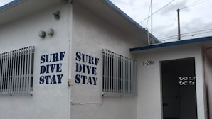 A building with 'SURF DIVE STAY' signs and a door labeled 'S-288'. - Life Rock (Chatan)