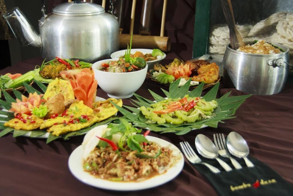 A table with various dishes, a teapot, and a set of utensils.