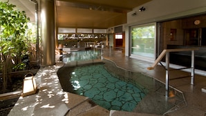 An indoor swimming pool with a tiled floor, surrounded by walls and a window. - Yunokuni Tensyo (Kaga)