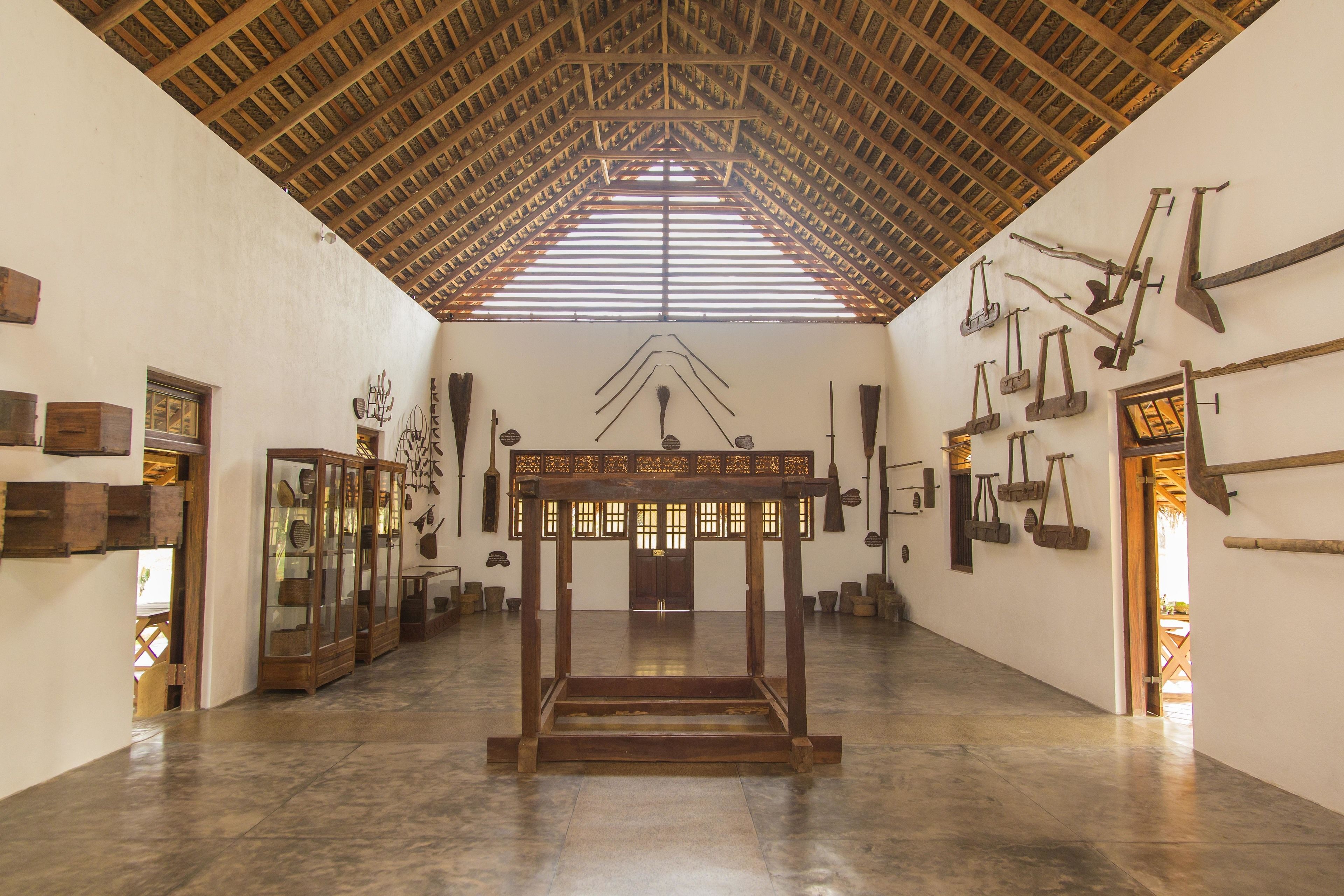 A spacious hall with a high wooden ceiling and a central wooden table.