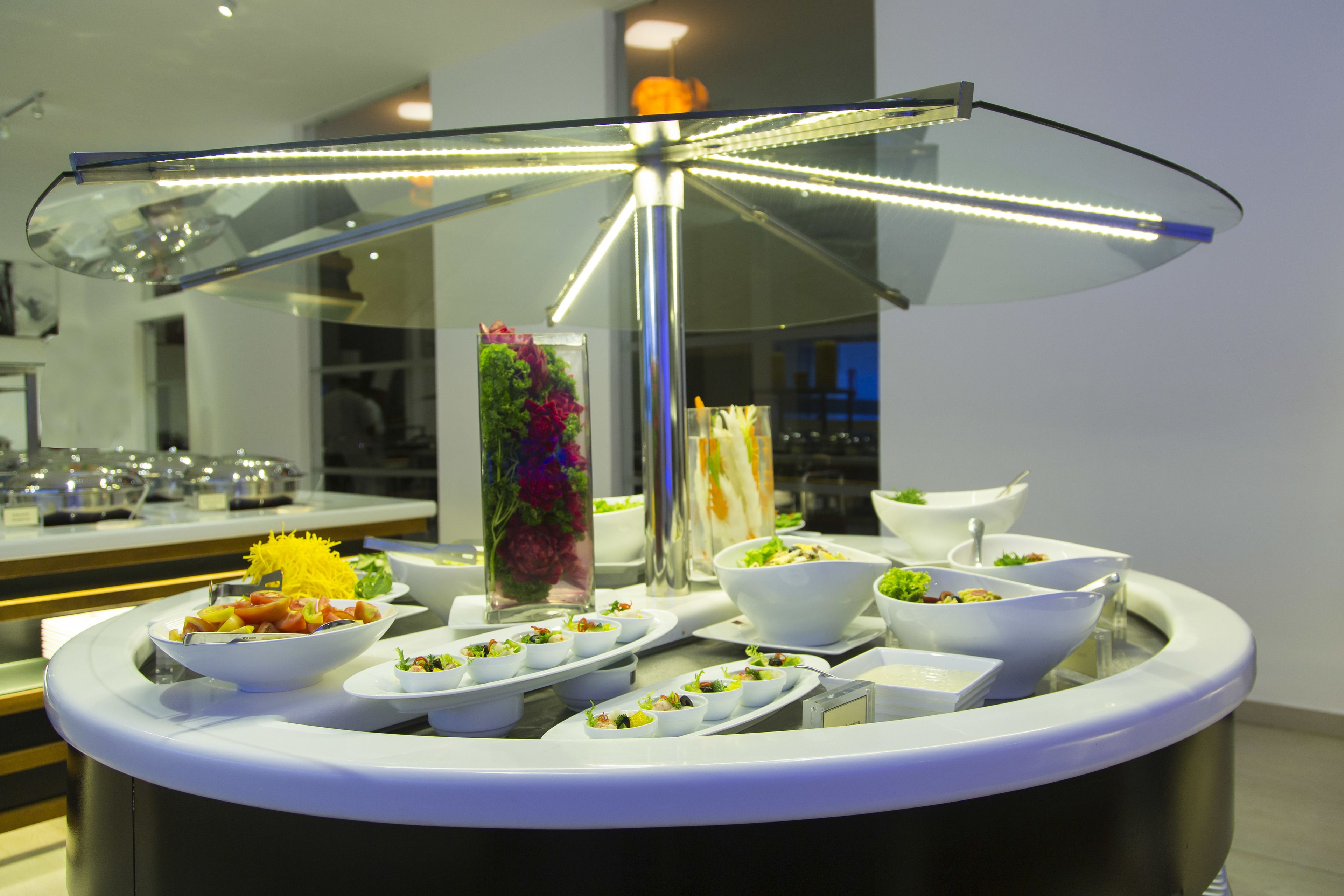 A buffet setup with various dishes and a decorative centerpiece.