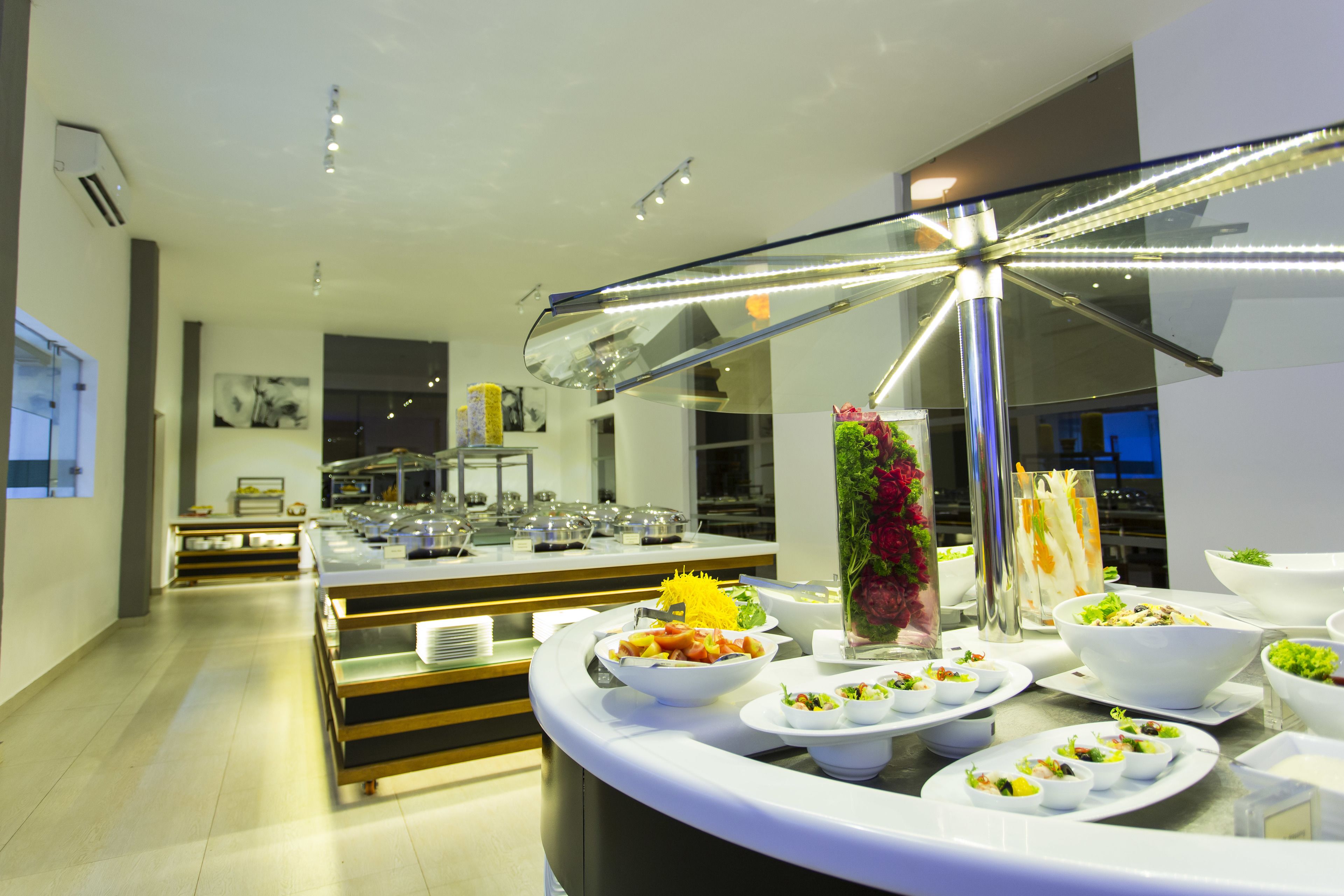 A buffet setup with various dishes and a decorative centerpiece.