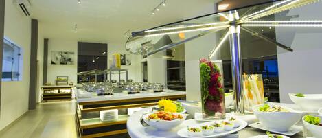 A buffet setup with various dishes and a decorative centerpiece.