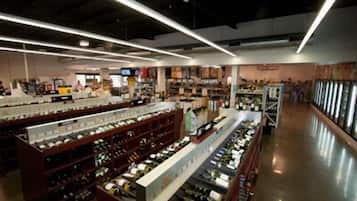 A wine store with shelves of bottles and a variety of wine-related products.