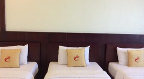 Three single beds with white linens and beige pillows featuring a red logo. - Cuu Long Hotel (Can Tho)