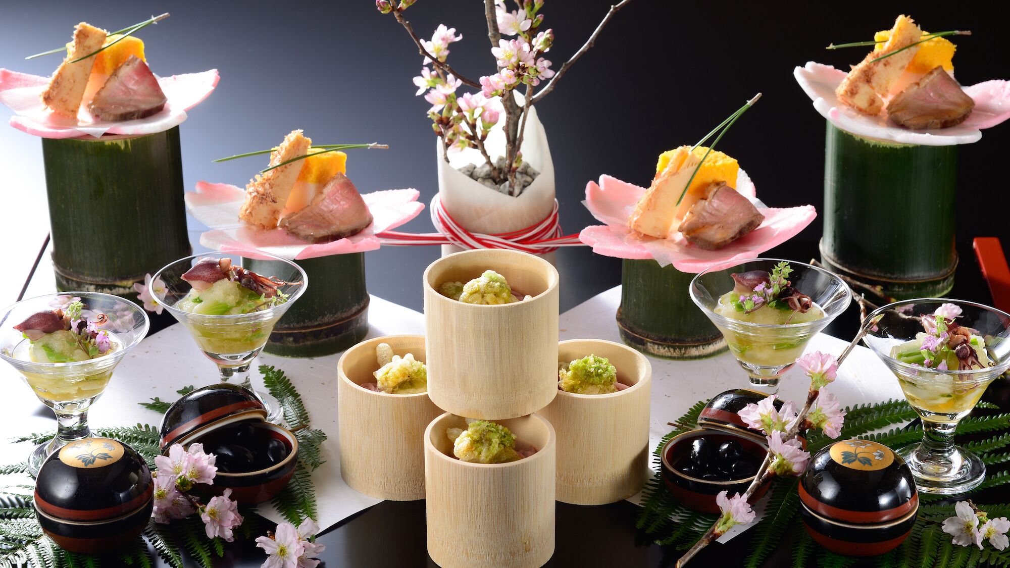A table with various food items, including dishes with meat and vegetables, and some in glass containers.