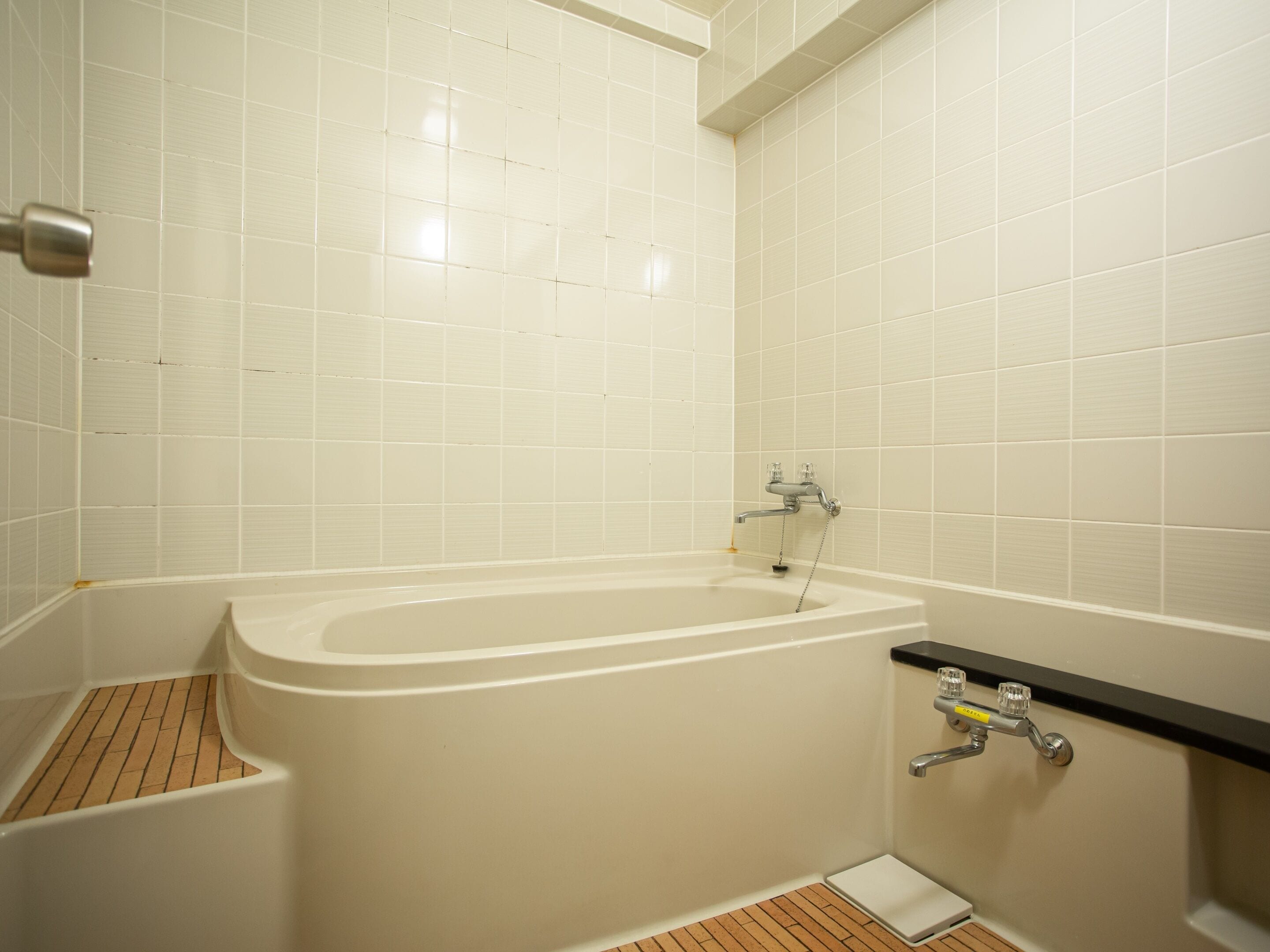 Een badkamer met een bad, een douche en een toilet.