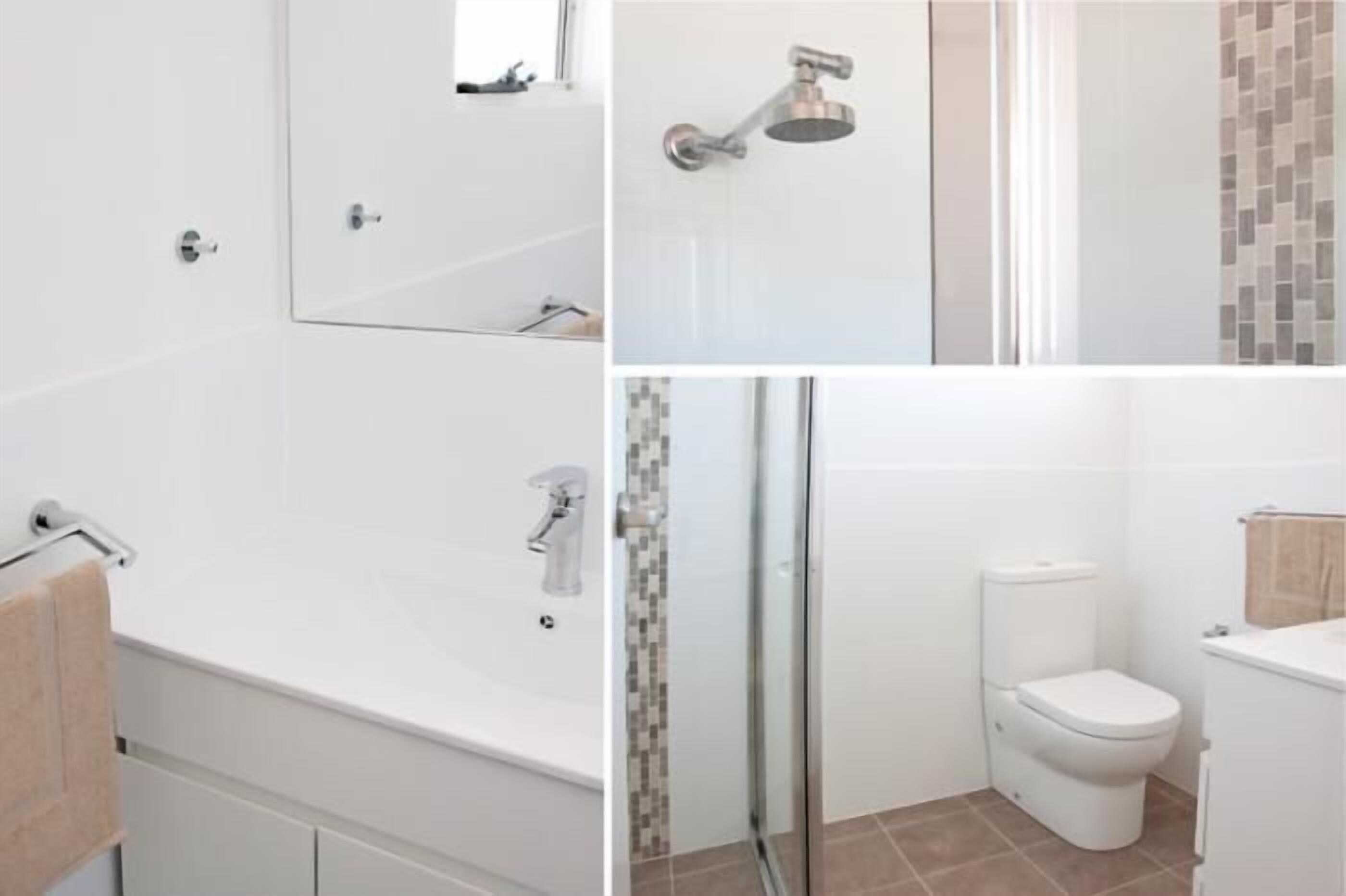 A modern bathroom with a bathtub, a shower, and a toilet.