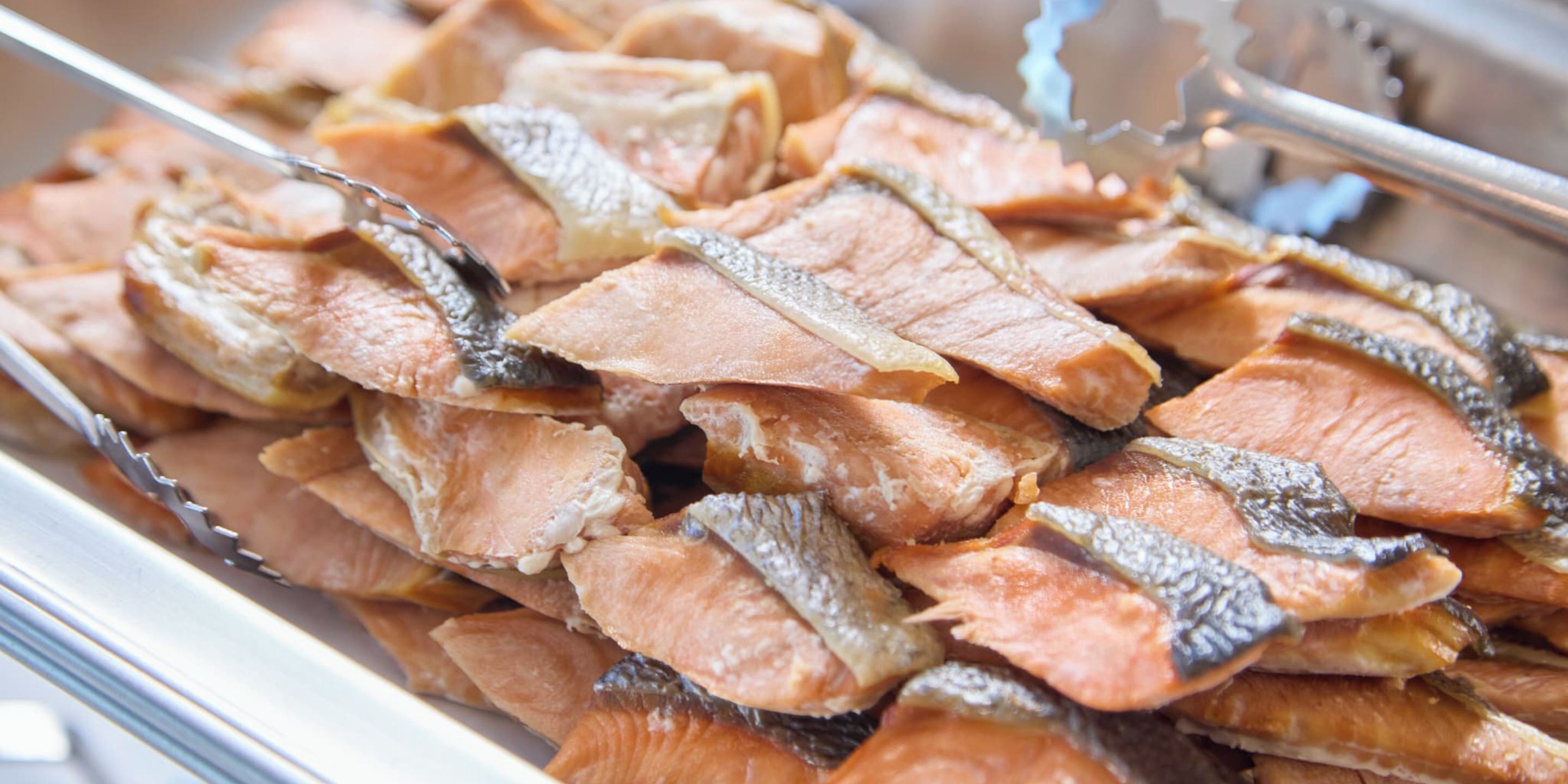A tray of dried fish, likely prepared for cooking or serving.