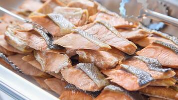 A tray of dried fish, likely prepared for cooking or serving.