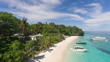 On the beach, white sand, sun loungers, beach umbrellas
