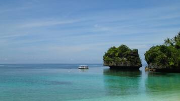On the beach, white sand, sun loungers, beach umbrellas