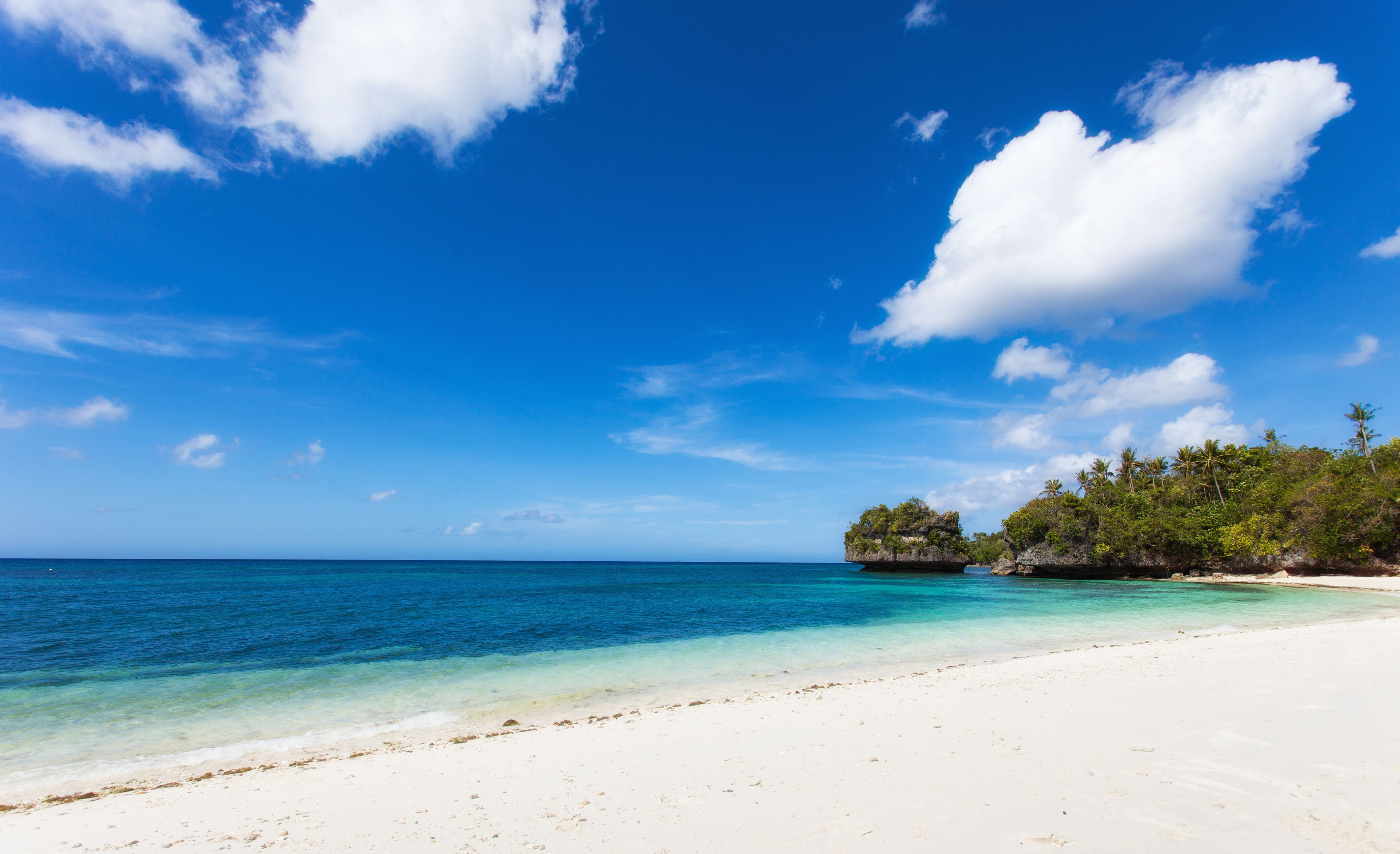 On the beach, white sand, sun-loungers, beach umbrellas