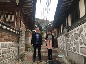 Une ruelle étroite aux bâtiments d’architecture traditionnelle, avec notamment des poutres en bois et des toits en tuiles.