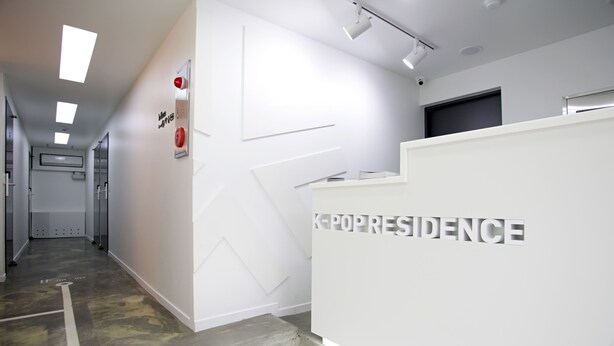 A modern reception area with a clean, white interior and a reception desk labeled "K-POPRESIDENCE". - K-Guesthouse Dongdaemun Premium 2 (Seoul)