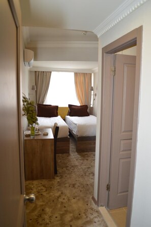 A hotel room with two beds, a desk, and a window with curtains. - Nobel Hotel Ankara (Ankara)