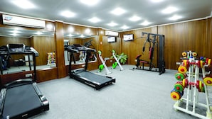A gym with treadmills, exercise bikes, and a weight rack. - Nascent Gardenia Baridhara (Dhaka)